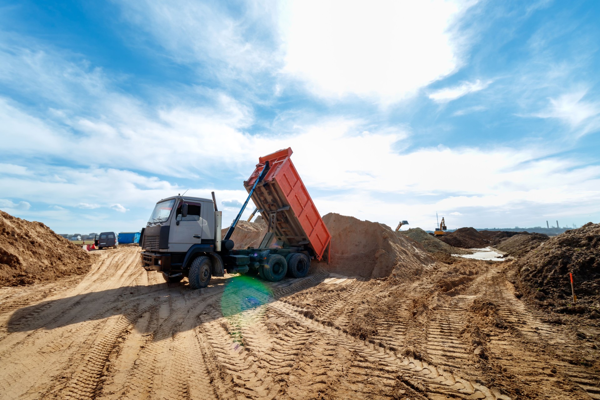 Delivery of sand to the construction site by truck with raised body